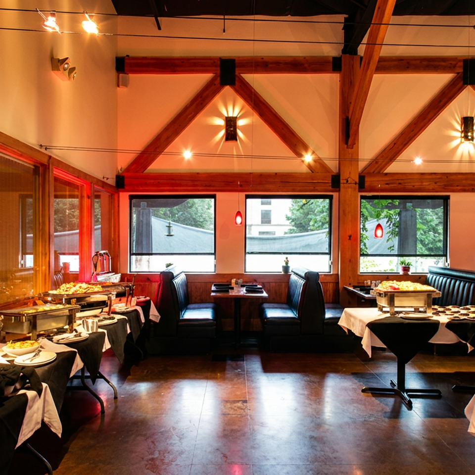 A restaurant interior with buffet tables, booths, large windows, and exposed wooden beams.